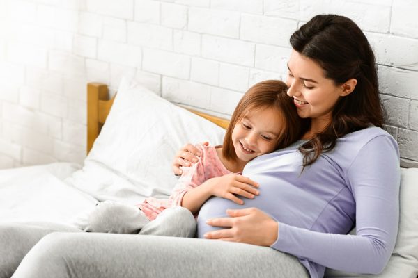 little-girl-and-pergnant-woman-bonding-on-bed-2025-03-18-19-24-41-utc